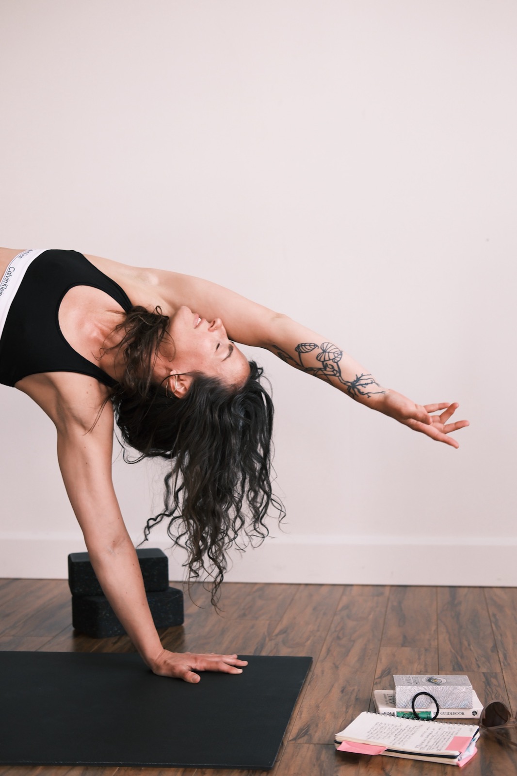Bonnie Weeks in a deep wild thing backbend on her mat, one arm reaching back toward the floor